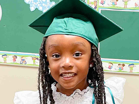 This is a photo of a Head Start student at a recent ceremony 
